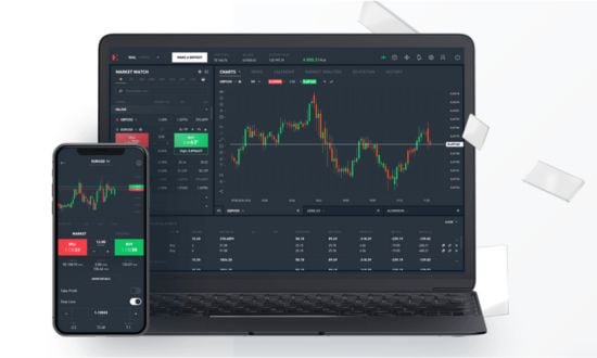 Grafici di trading su laptop e smartphone, piattaforma di investimento.